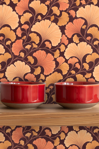 Muted orange and gold ginkgo foliage pattern applied on an interior bathroom wall.