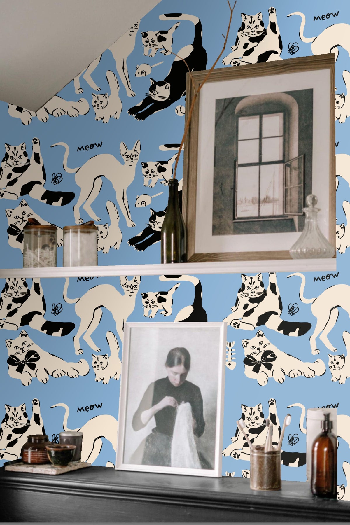 Close-up of black and cream cats in various playful poses on blue wallpaper