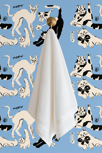Black and cream cat paw prints and playful line doodles on blue background