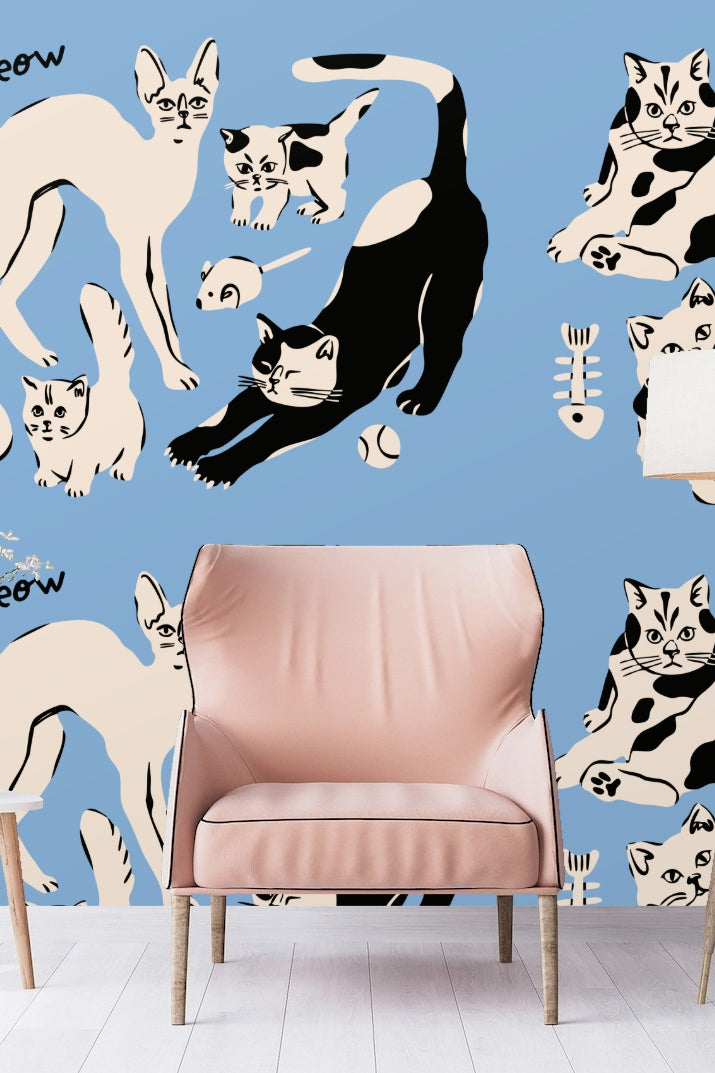 Original artwork showing playful stylized cats in black and cream on blue background