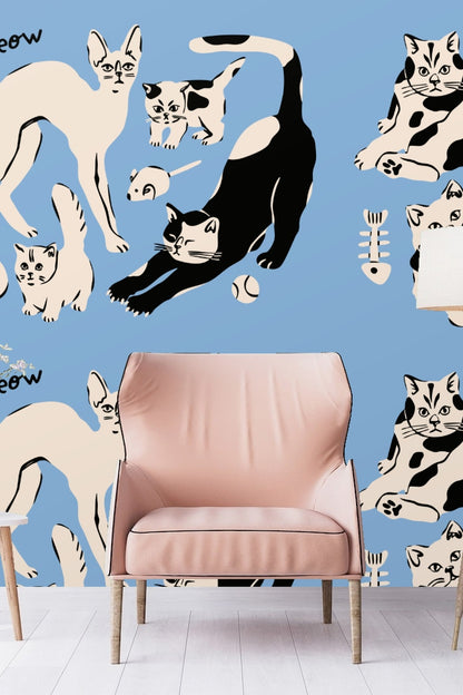 Original artwork showing playful stylized cats in black and cream on blue background