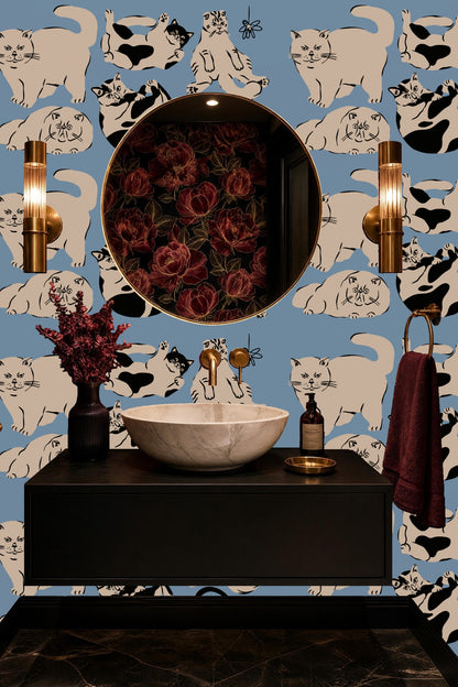 Black cat stretching toward a butterfly motif on blue wallpaper