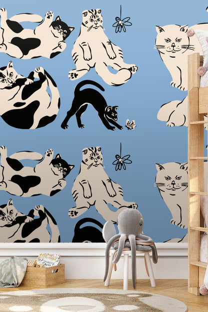 Wallpaper design showing stylized cream and black cats outlined in black on a blue background
