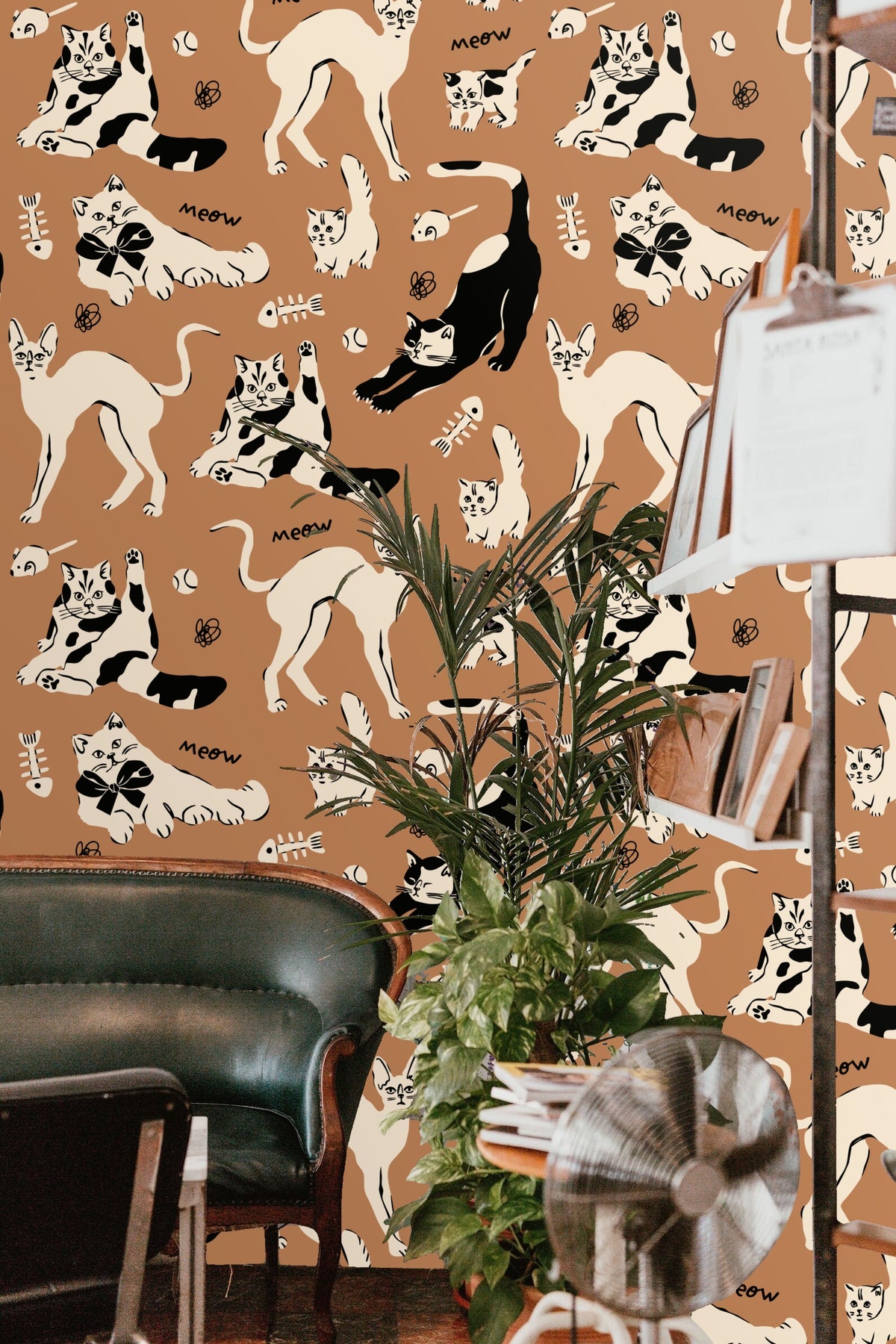 Pattern detail of cats in black and cream on sienna background