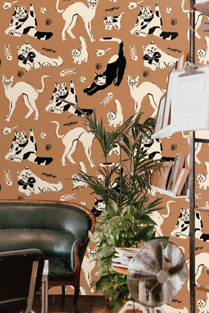 Pattern detail of cats in black and cream on sienna background