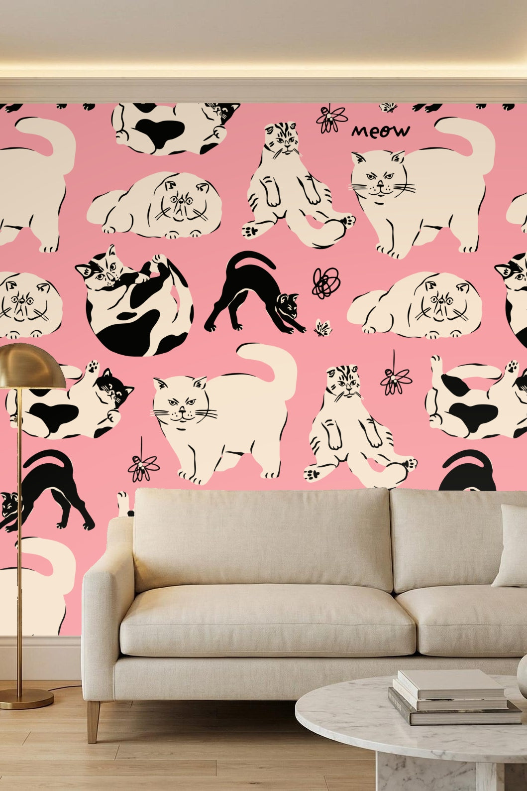 Bathroom scene with freestanding tub and vanity, walls covered in pink wallpaper with black and cream cat motifs