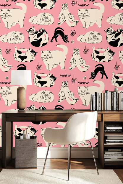 Pattern repeat showing black doodle cats in various playful poses on pink background