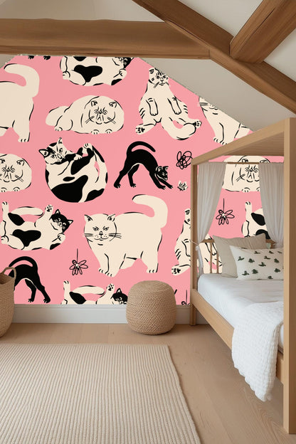 Detail of cream and black cats on pink wallpaper with handwritten 'meow'