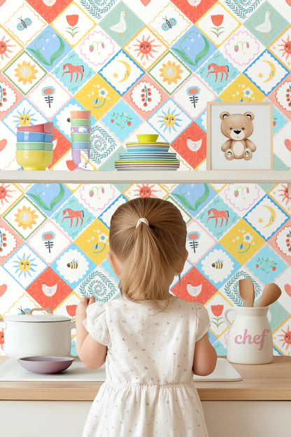Sun and moon faces with coral and blue backgrounds in patchwork wallpaper