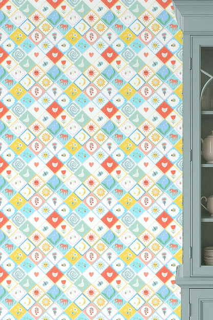 Kitchen wall with Folk Patchplay wallpaper behind blue cabinet