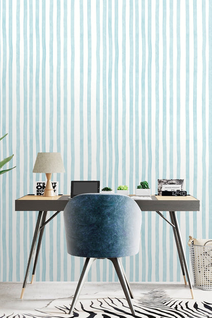 Wall with a wooden dresser styled with plant and decor against Rippled Sky Lines wallpaper