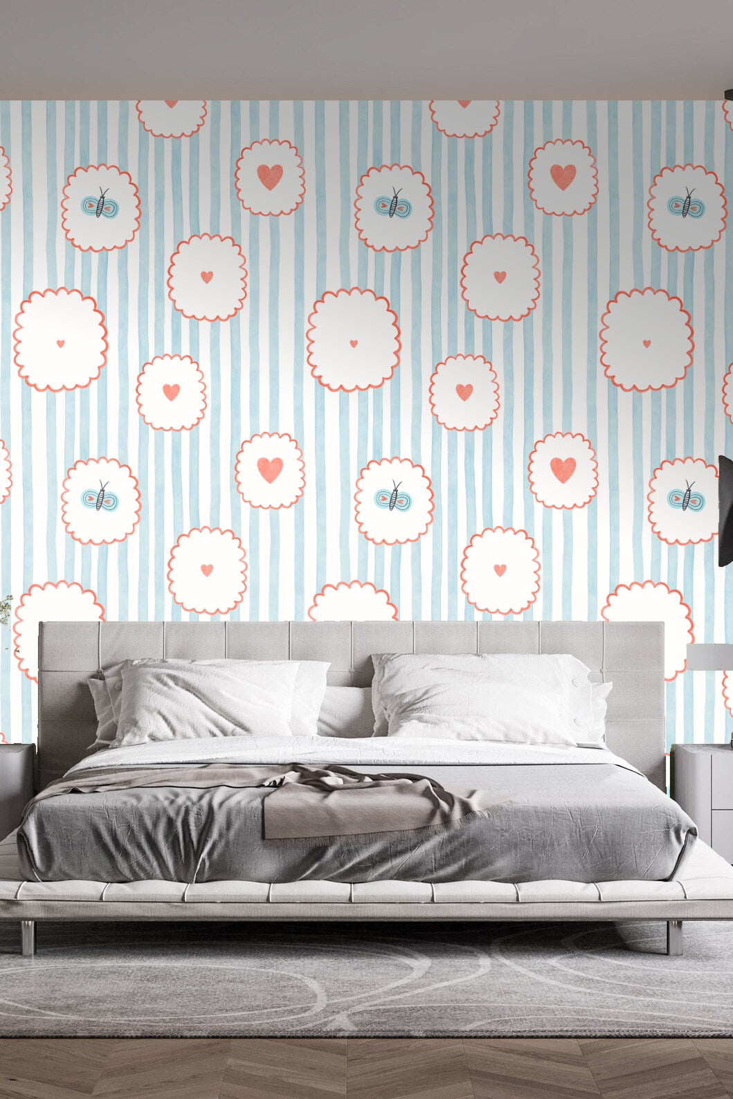 Bedroom wall adorned with the wallpaper behind a gray upholstered bed with pendant lights