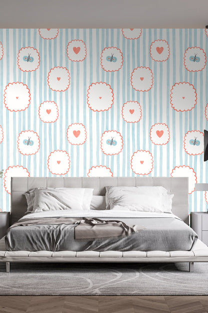 Bedroom wall adorned with the wallpaper behind a gray upholstered bed with pendant lights