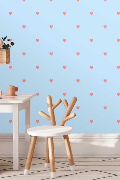 Modern bedroom featuring powder blue wallpaper with coral heart pattern behind wooden bed