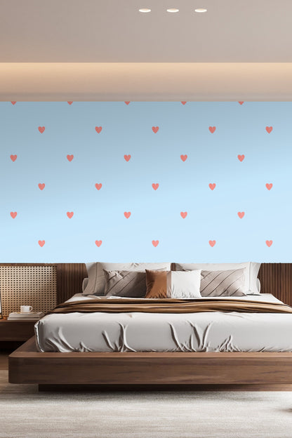 Powder blue wall with coral heart wallpaper behind a pile of white gift boxes