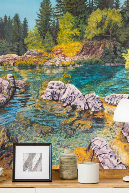 Naturalistic depiction of water reflecting golden sunlight on rocks and vegetation in wallpaper.