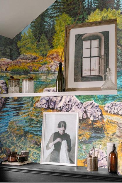 Lush green trees and yellow grasses reflected in still river water, depicted in wallpaper mural.