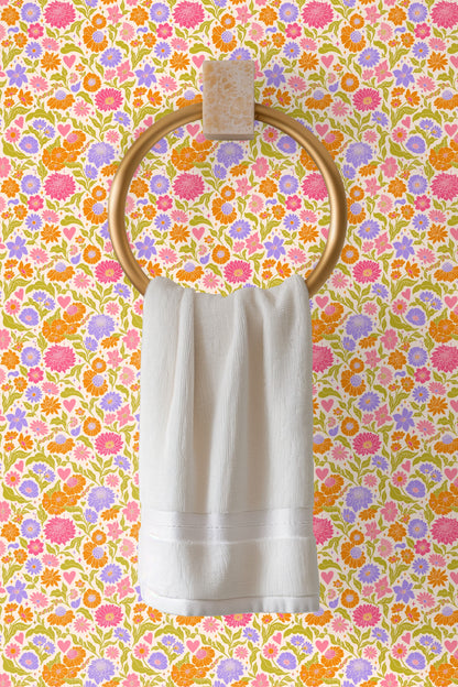Section of wall with Retro Pop Floral Tile wallpaper lit by natural window light, highlighting flower details.