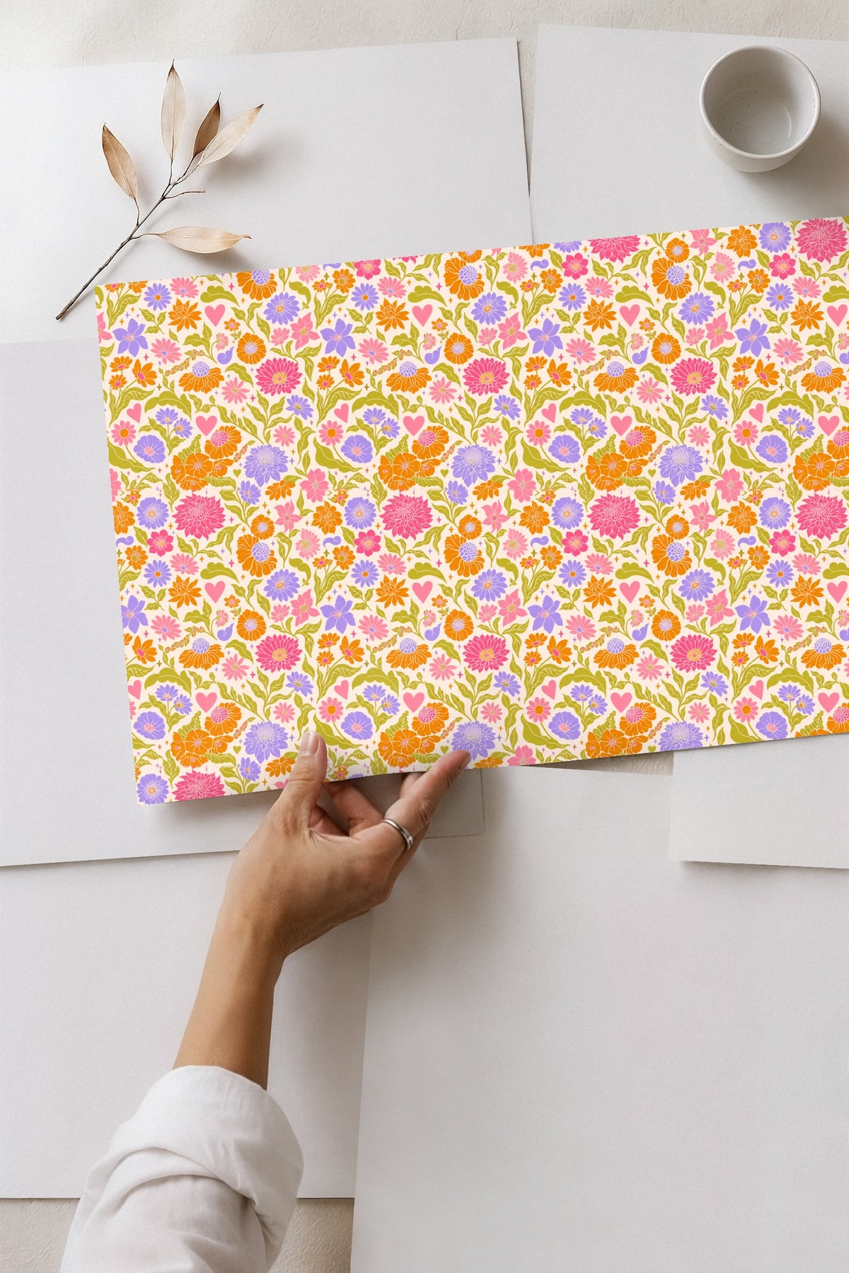 Flower motifs including a large pink bloom and orange blossoms in the wallpaper pattern.