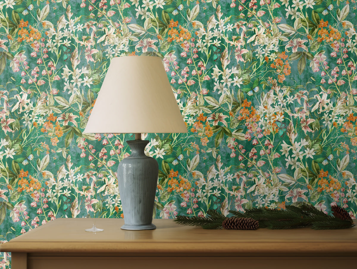 Interior vignette with textured cushions and ceramics grounding the vibrant floral backdrop.