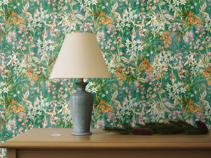 Interior vignette with textured cushions and ceramics grounding the vibrant floral backdrop.