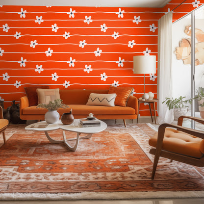 Bathroom vignette: open medicine cabinet against the daisy-stripe wallpaper, showing small cream flowers on a vivid orange background.
