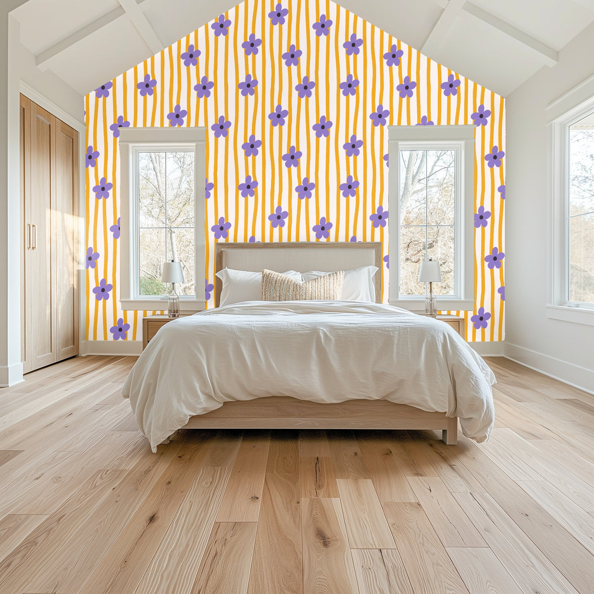 Detail view of the wallpaper above a bed with a green scalloped headboard showing flower spacing and stripe rhythm