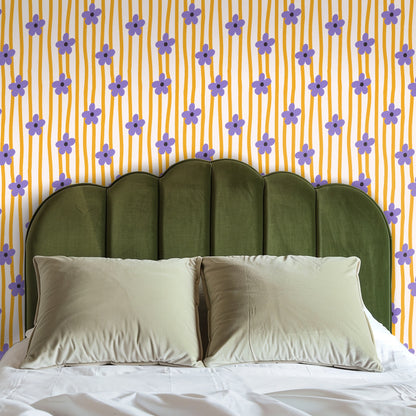 Wide living room wall covered in the pattern behind a low orange sofa illustrating full-wall application