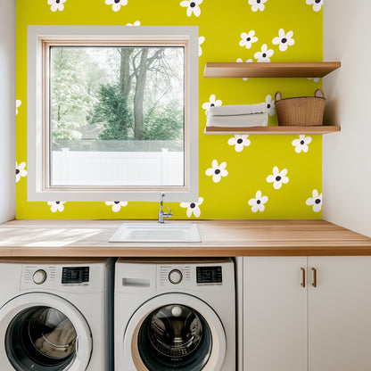 Close-up of Citron Bloom pattern: white five-petal flowers with charcoal centers on a vivid chartreuse background.