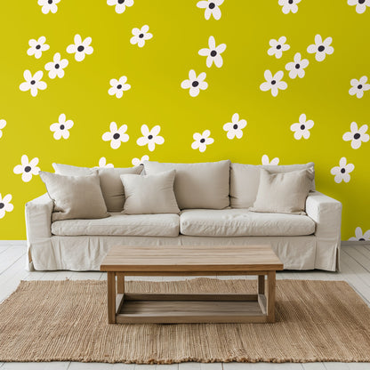 Living room accent wall in Citron Bloom with a neutral sofa, textured rug and warm-toned accent chair.
