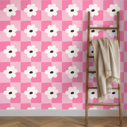 Bedside view with white linens and the wallpaper as a bold but warm headboard backdrop