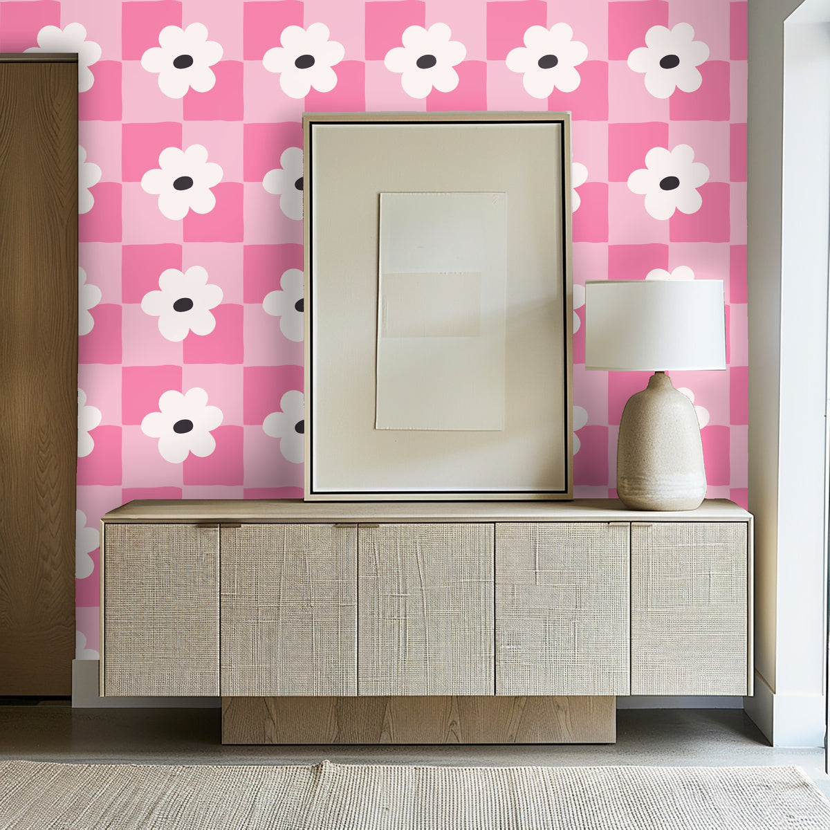 Close-up still life: candle and vase in front of the pink checker-and-flower wallpaper