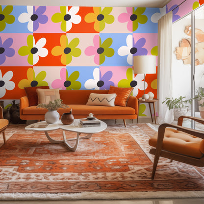 Living room vignette with Patchwork Bloom covering an accent wall behind an orange mid-century sofa, the pattern scaled to large tiles.