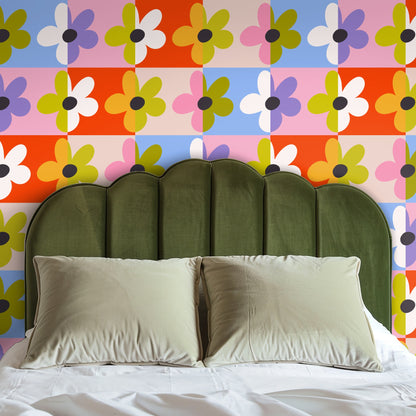 Detail shot of the pattern behind a side table and lamp, emphasizing the half-and-half petal motif and bright color blocking.