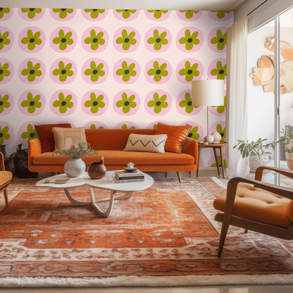 Pink scalloped headboard beside a wall covered in Petal Orbit wallpaper, highlighting the pink and olive color pairing.