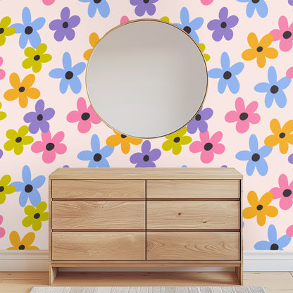 Kitchen or bedside vignette showing floral wallpaper with a candle and small glass bud vase in front.