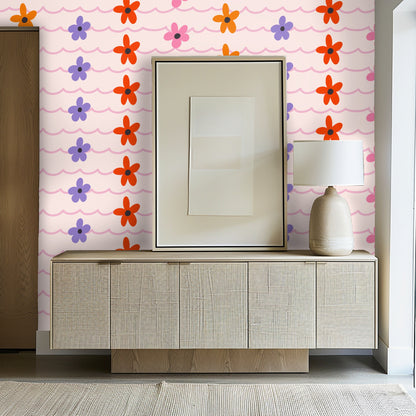 Detail of scalloped horizontal lines and evenly spaced stylized flowers in dusty-pink, orange, red and lavender