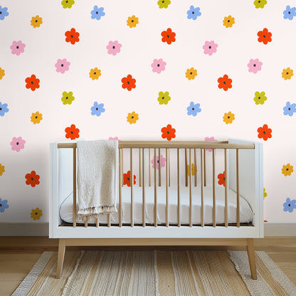 Coral velvet headboard and pillows framed by the scattered posy pattern on a soft blush wall