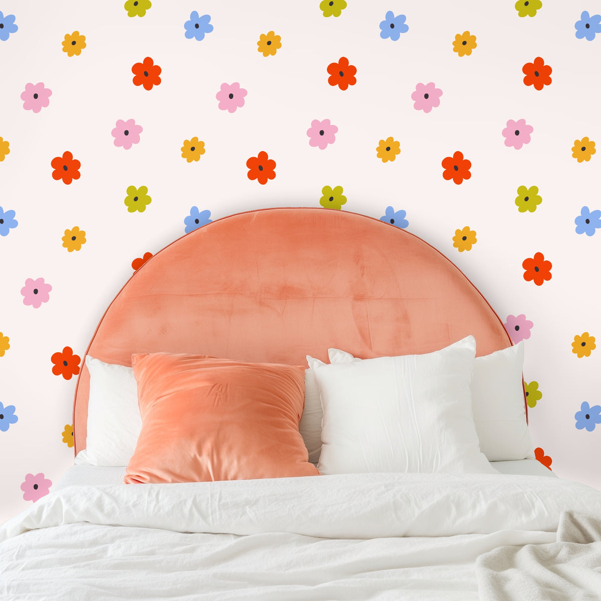 Bedroom headboard shot: mustard velvet headboard against Petite Posy wallpaper highlighting color contrast
