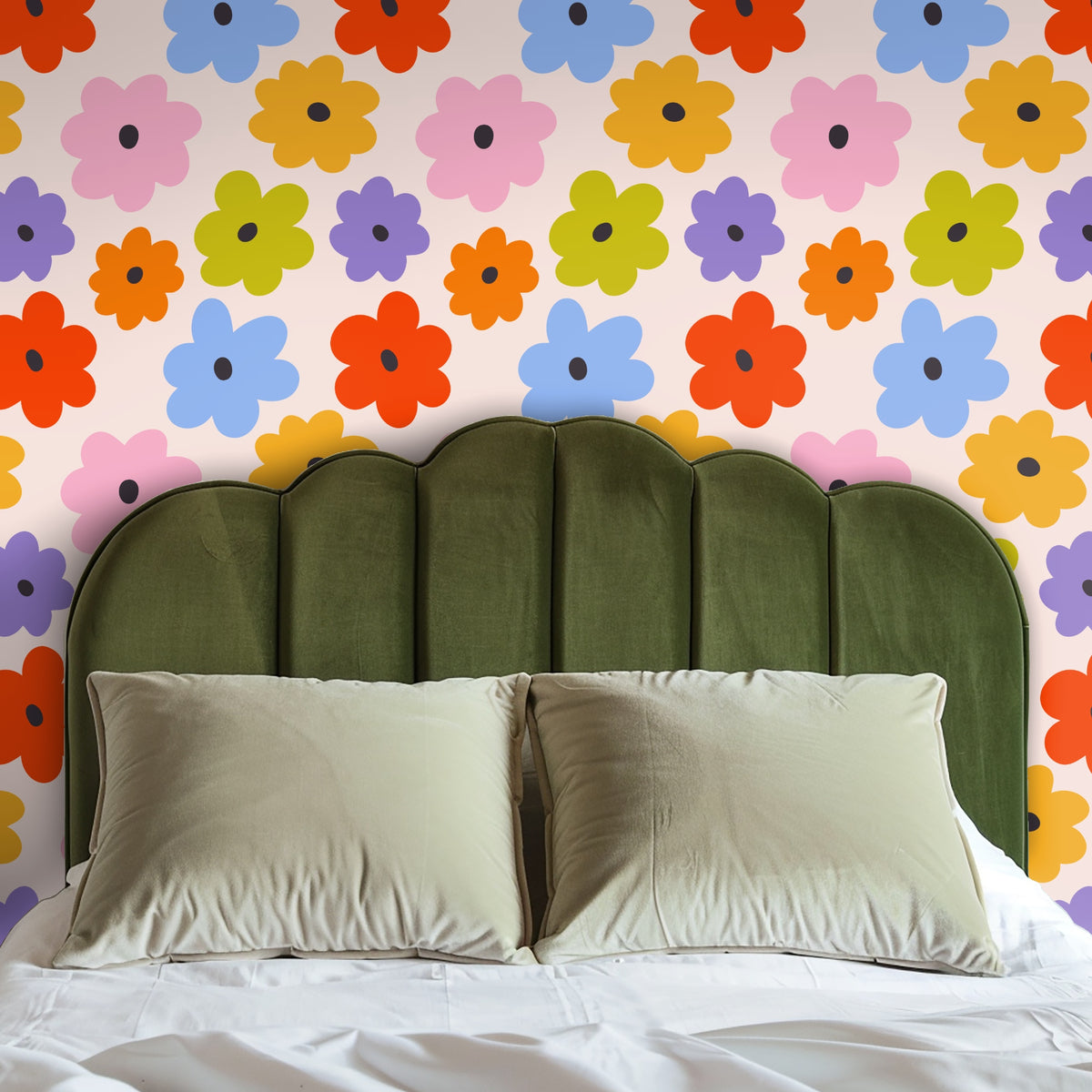 Close crop of wallpaper behind a leather armchair and marble side table, highlighting chartreuse, tangerine and sky-blue flowers
