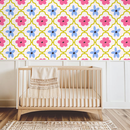 Detail of alternating five‑petal blue flowers and rounded pink blooms with charcoal centers on the wallpaper