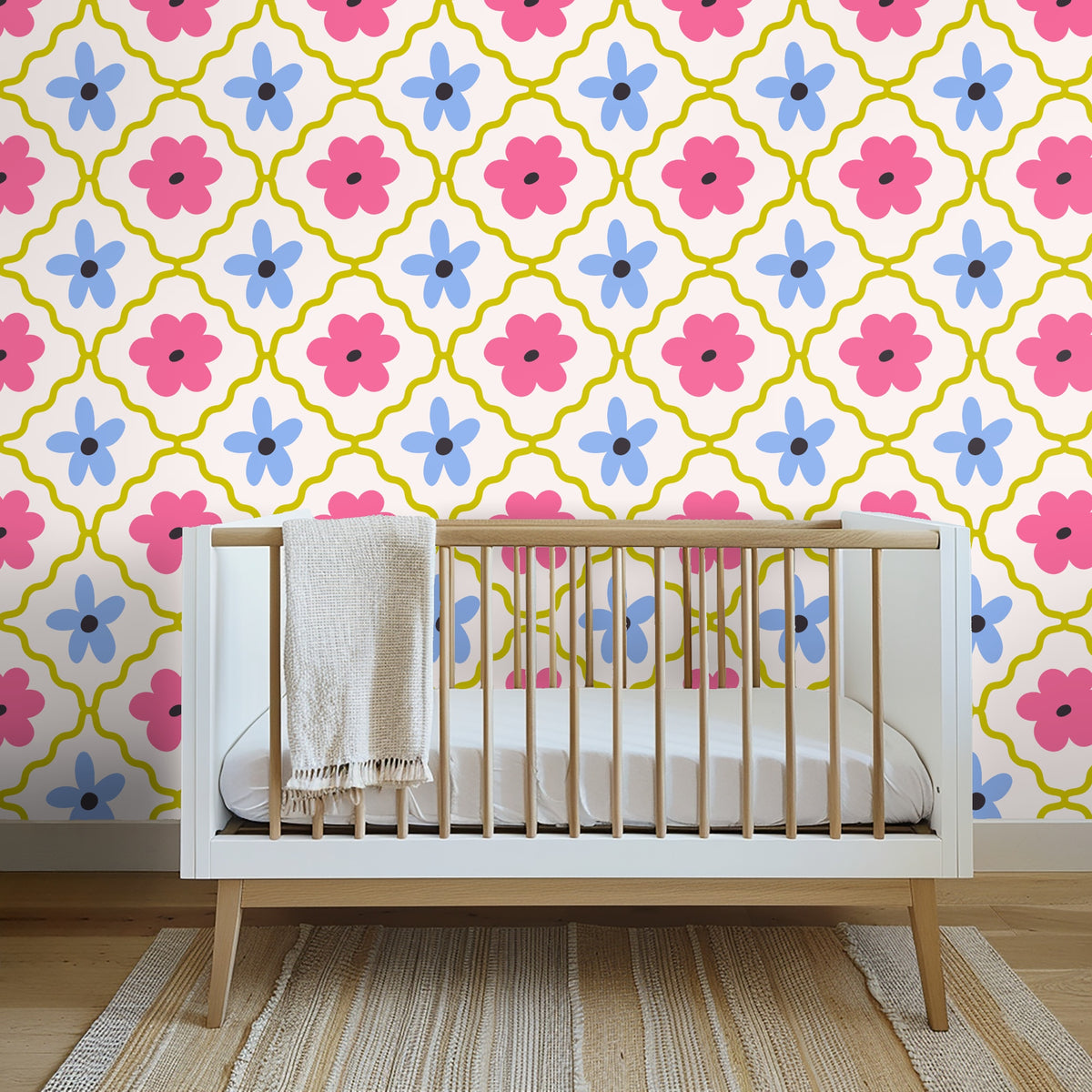 Wide nursery view with a light-wood crib and the wallpaper as a bold statement wall