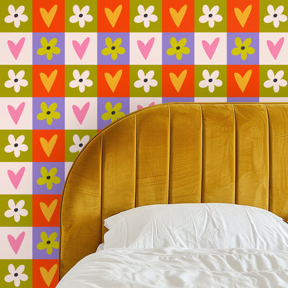 Bedroom mockup with full-height feature wall covered in the hearts-and-flowers checkerboard behind a simple bed and vaulted ceiling