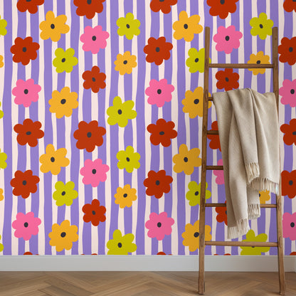 Wall detail showing the repeat and color interplay—hand-drawn lavender stripes, soft blush bands, and bold flat-colored flower shapes.
