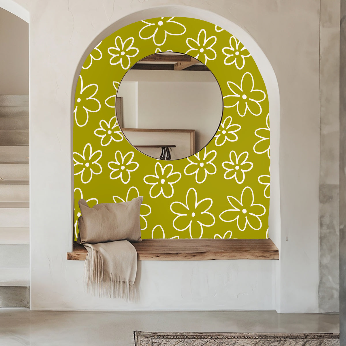 Entry alcove with round mirror framed by the chartreuse daisy wallpaper