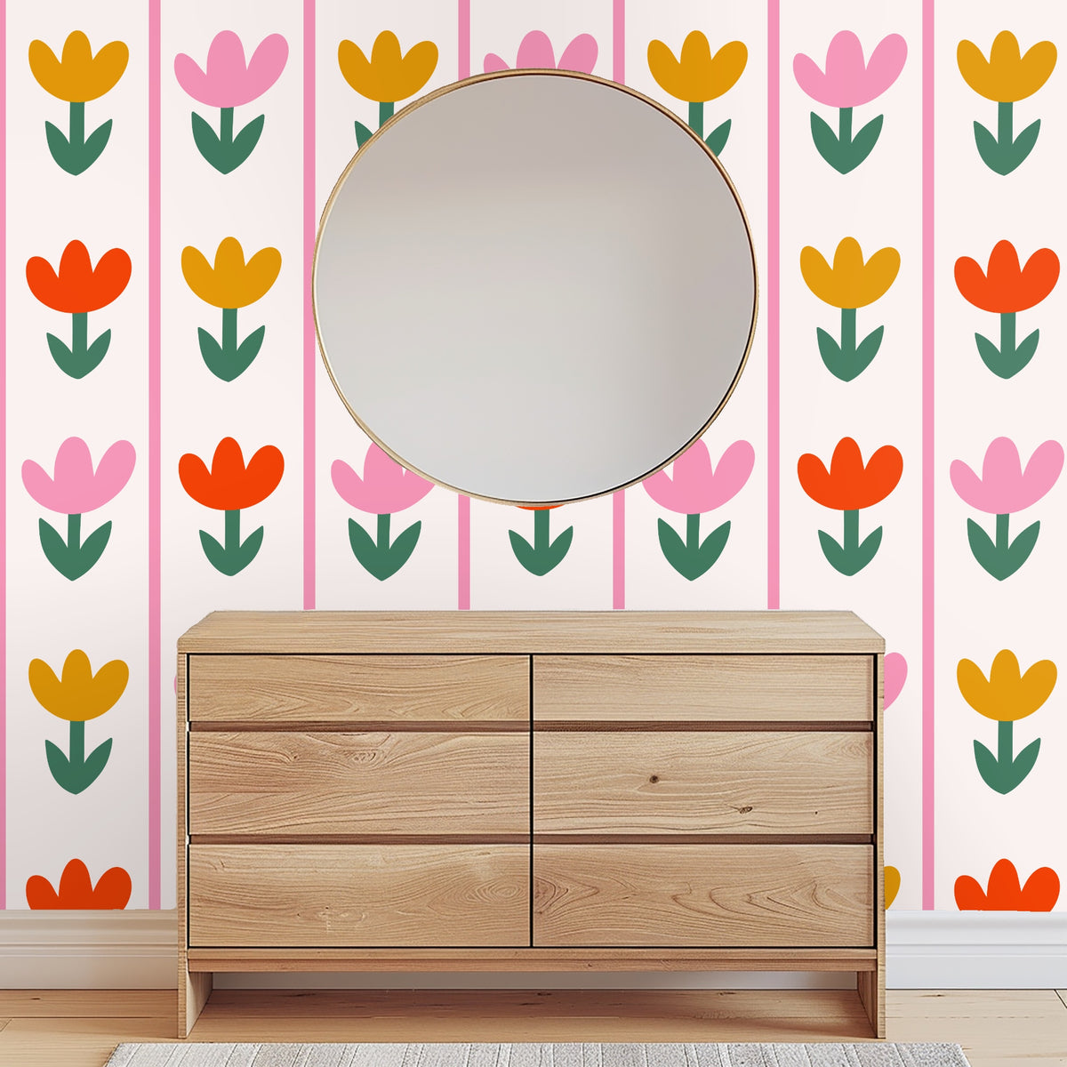 Mantel or tabletop styling with a candle and glass vase in front of Tulip Parade wallpaper, floral motif visible behind decor
