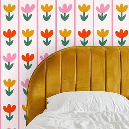 Close-up of Tulip Parade wallpaper showing rows of stylized tulips in pink, mustard and coral with green stems on a pale cream background