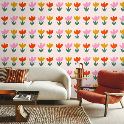 Close-up crop of pattern showing crisp flat color petals and paired green leaves on a blush field
