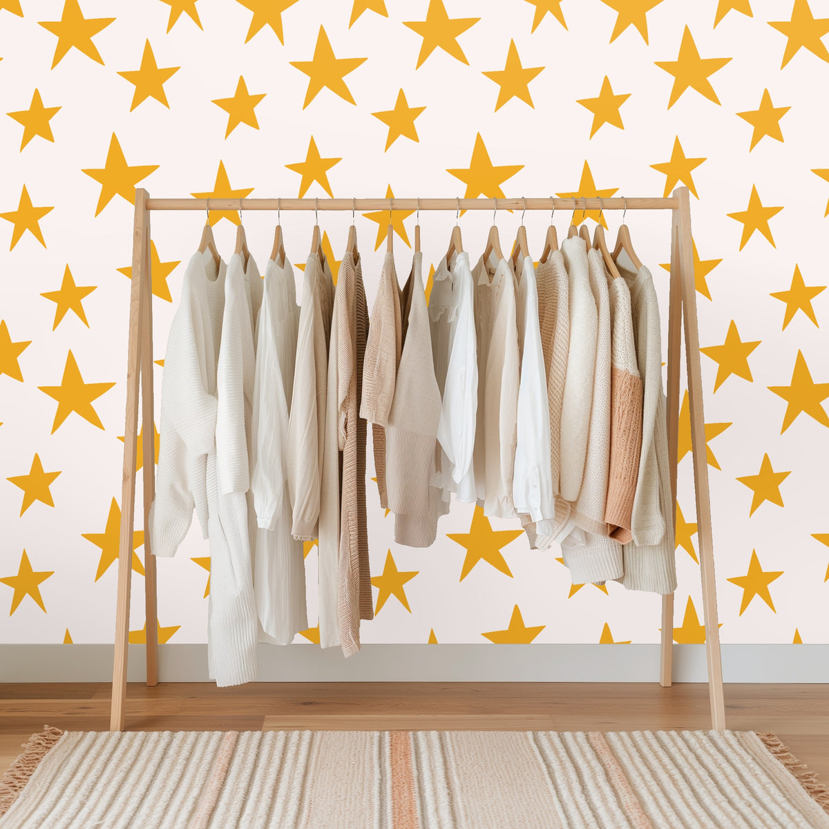 Wide wall view demonstrating the consistent repeat and medium spacing of mustard stars across the blush surface.