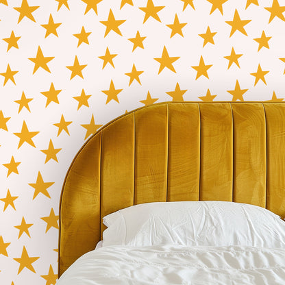 Close-up artwork: honey mustard five-point stars with slightly irregular edges on a pale blush background.